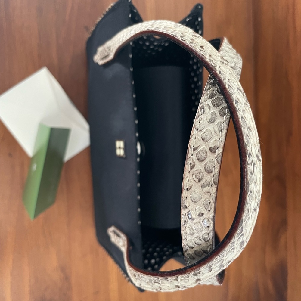 New Kate Spade, never wore. Black with snake handles.